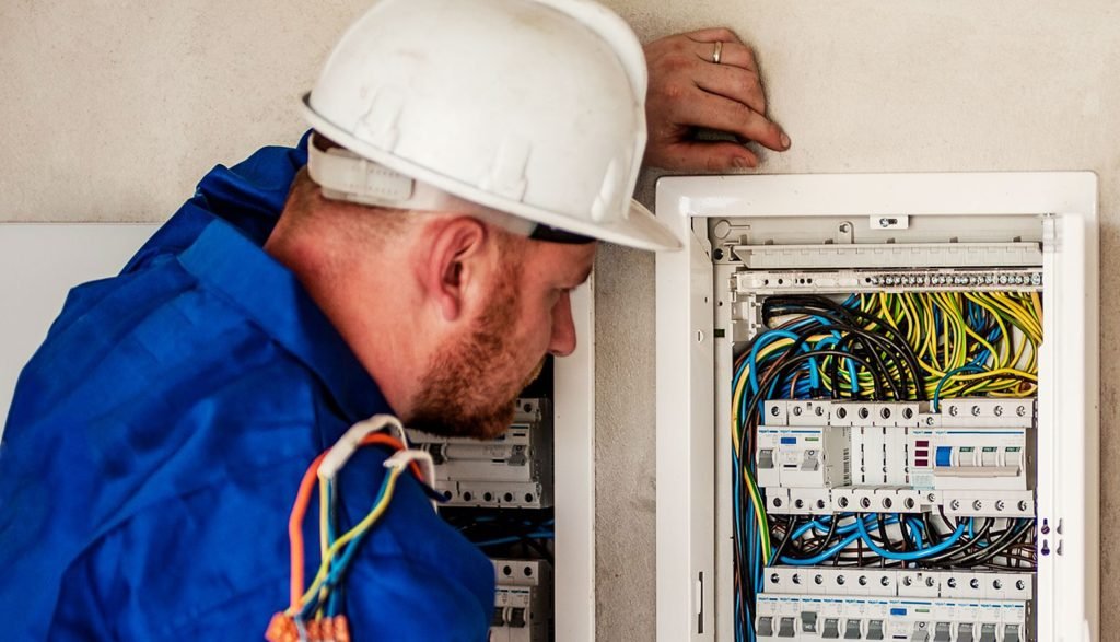 Engineer working at an electrical and control panel