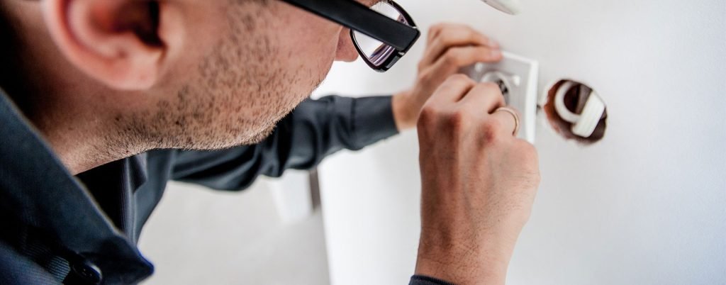 Technician working with a communication socket